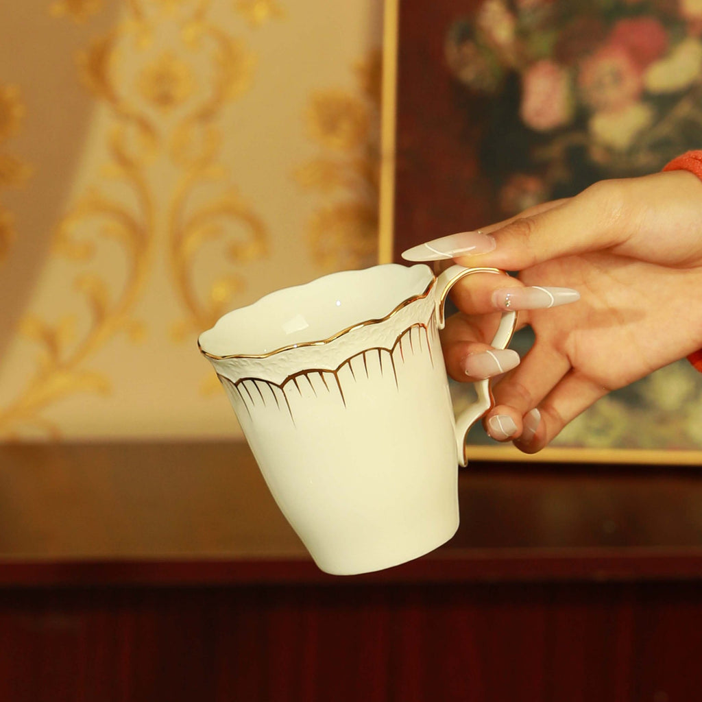 Embossed white ceramic mug with gold trim